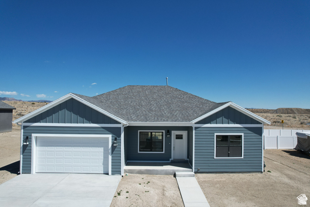 View of front of house featuring a mountain view and a garage