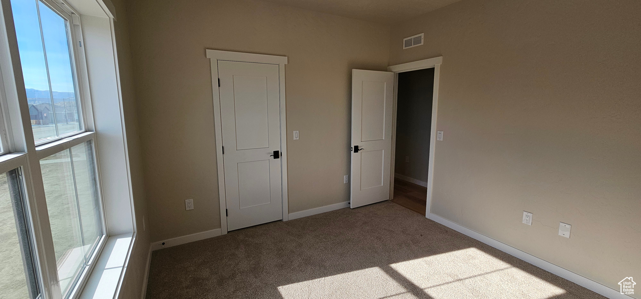 Unfurnished bedroom with carpet flooring