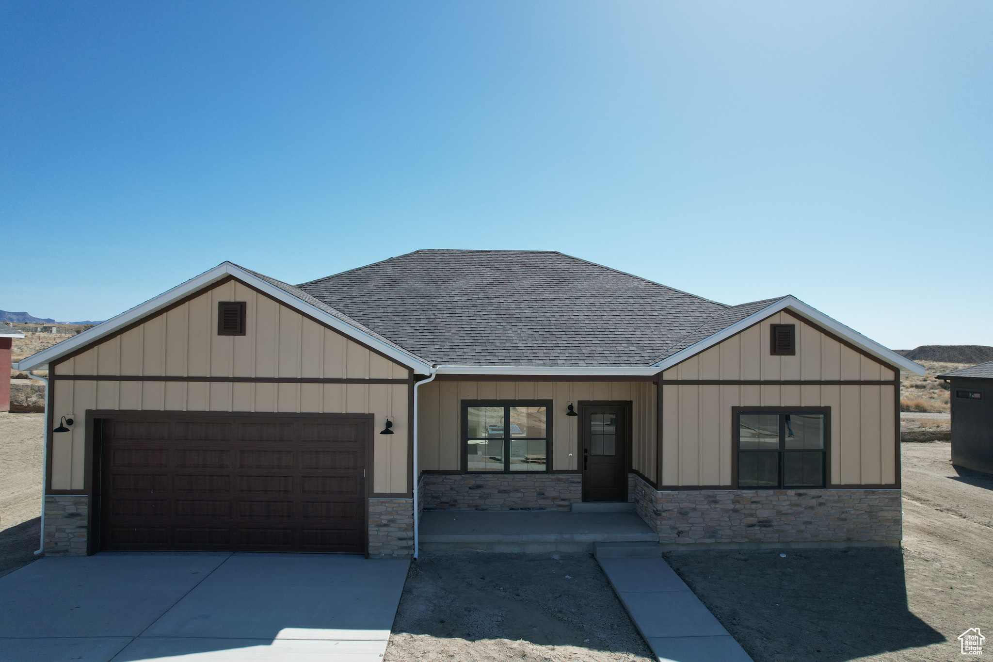 View of front of house with a porch and a garage