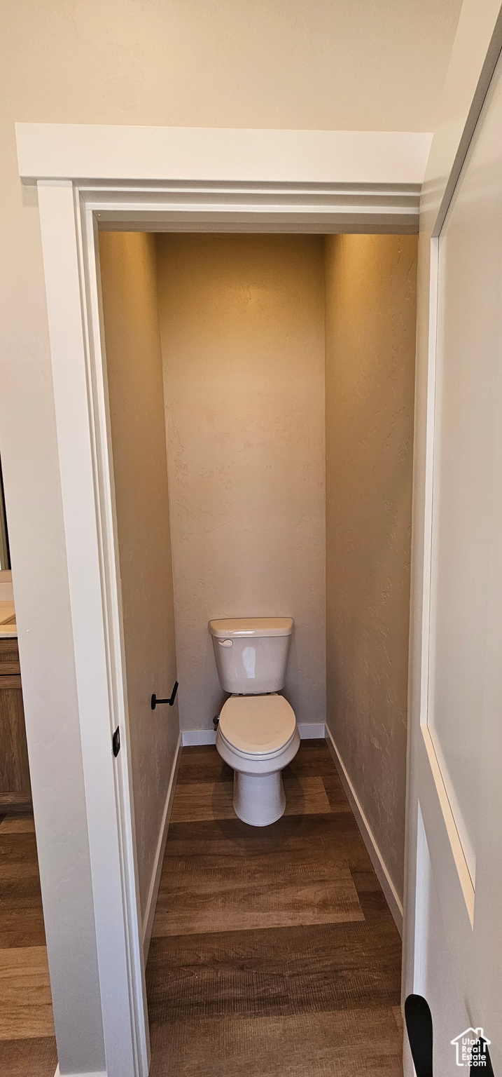 Bathroom featuring wood-type flooring and toilet