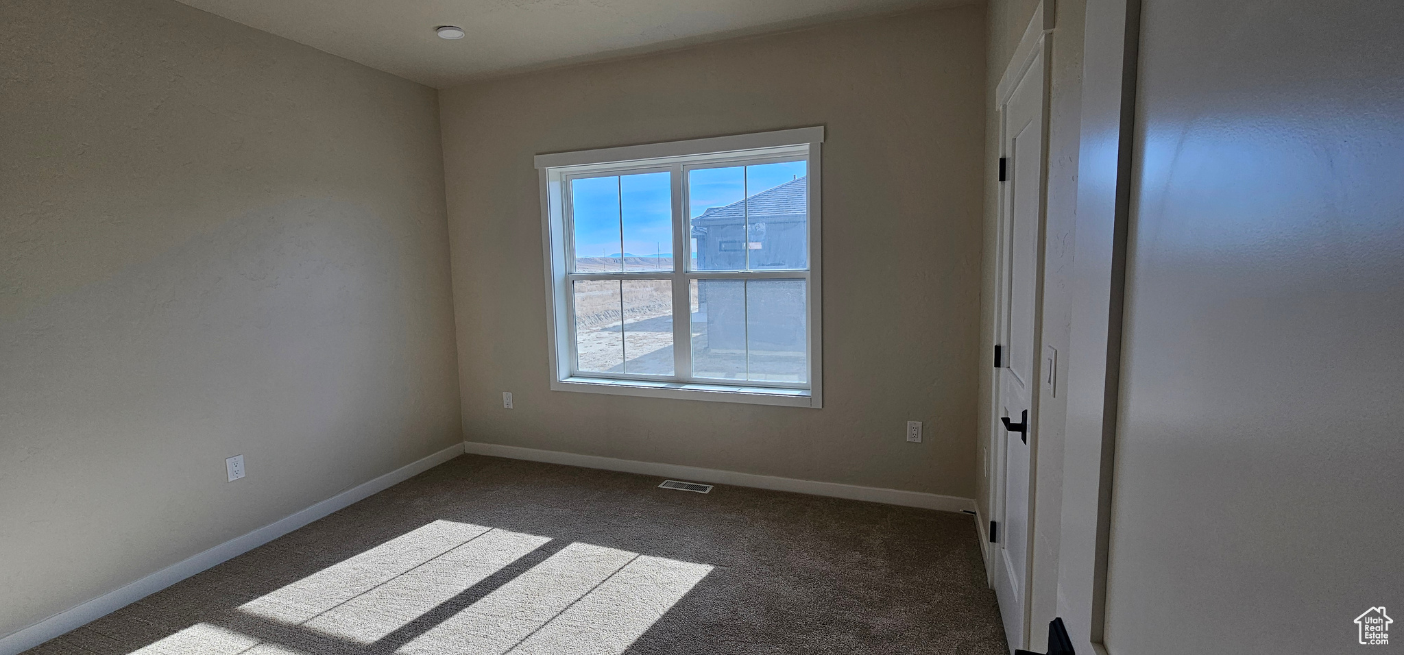 View of carpeted spare room