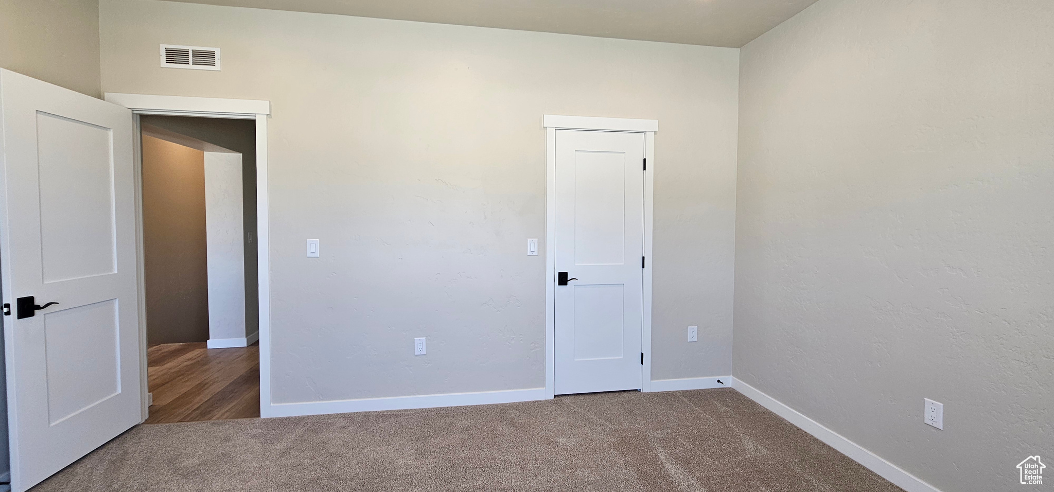 Unfurnished room with carpet