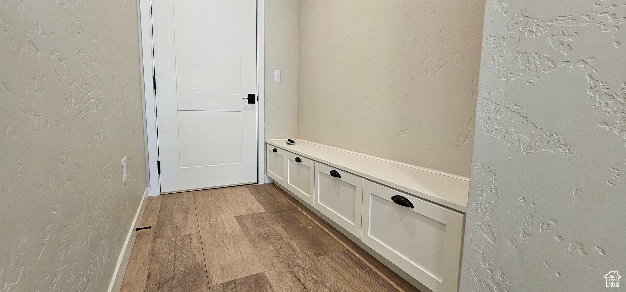 Mudroom with hardwood / wood-style flooring