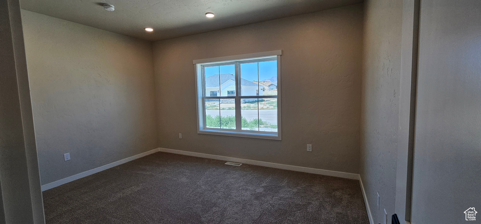 Carpeted empty room with a mountain view