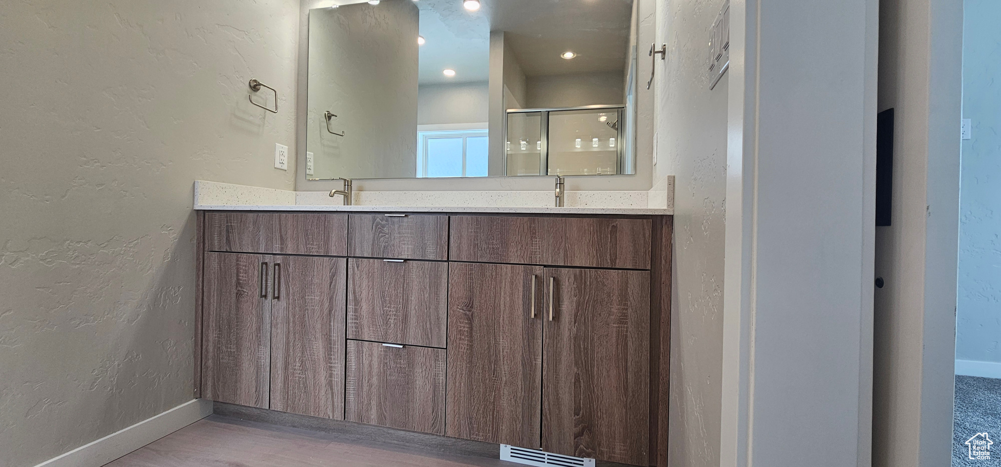 Bathroom featuring vanity and an enclosed shower