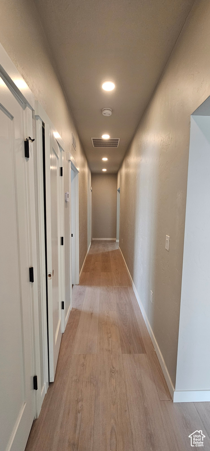 Hallway featuring light wood-type flooring