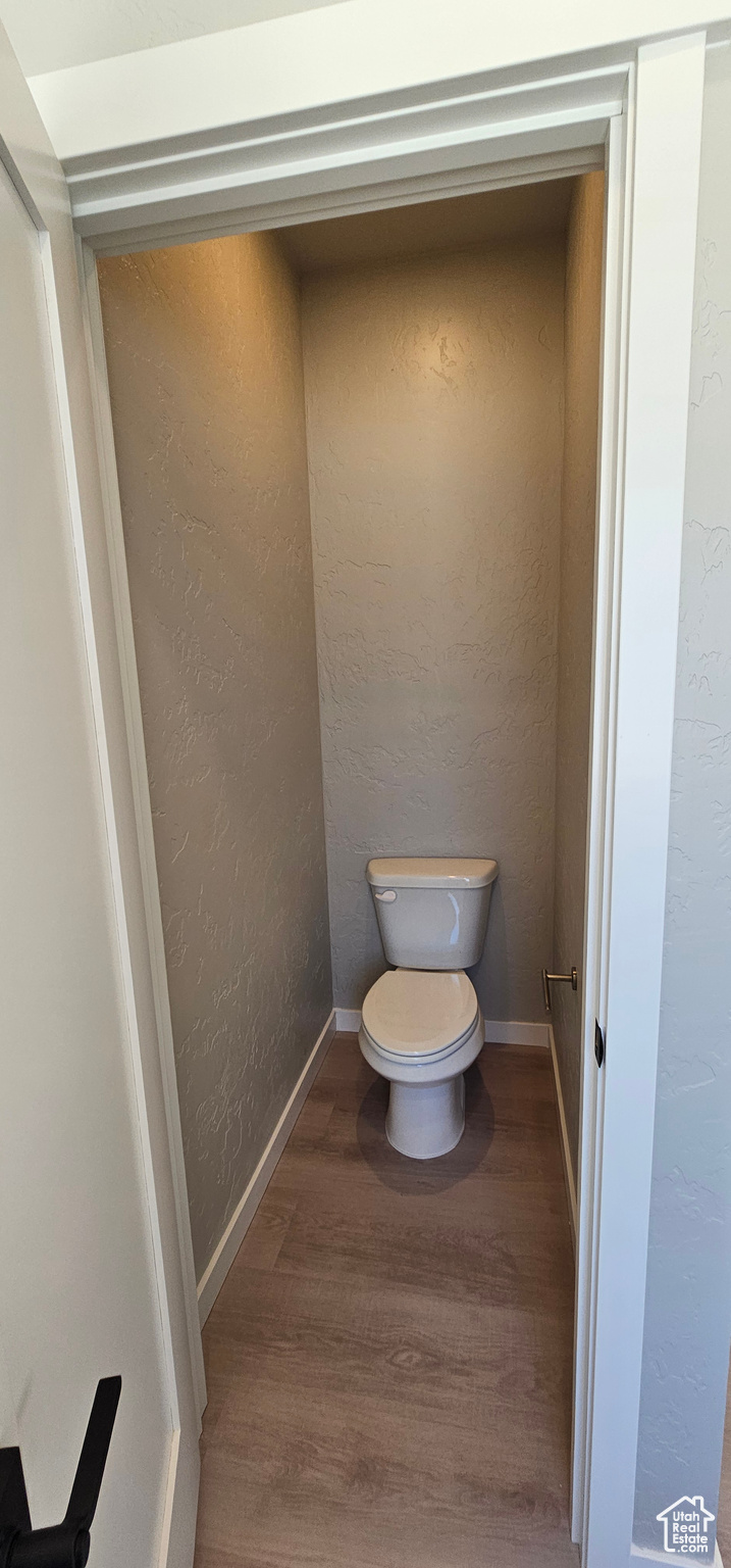 Bathroom featuring hardwood / wood-style flooring and toilet