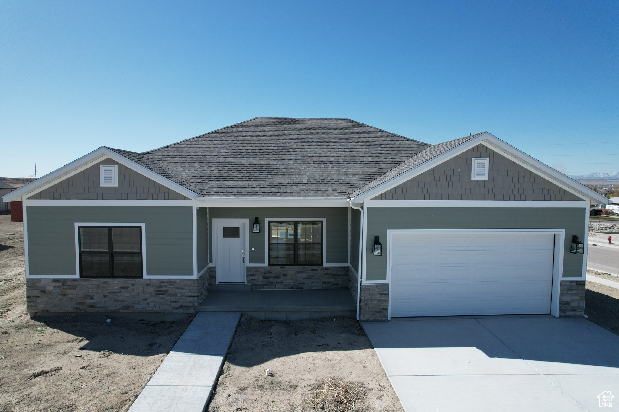 Craftsman inspired home featuring covered porch and a garage