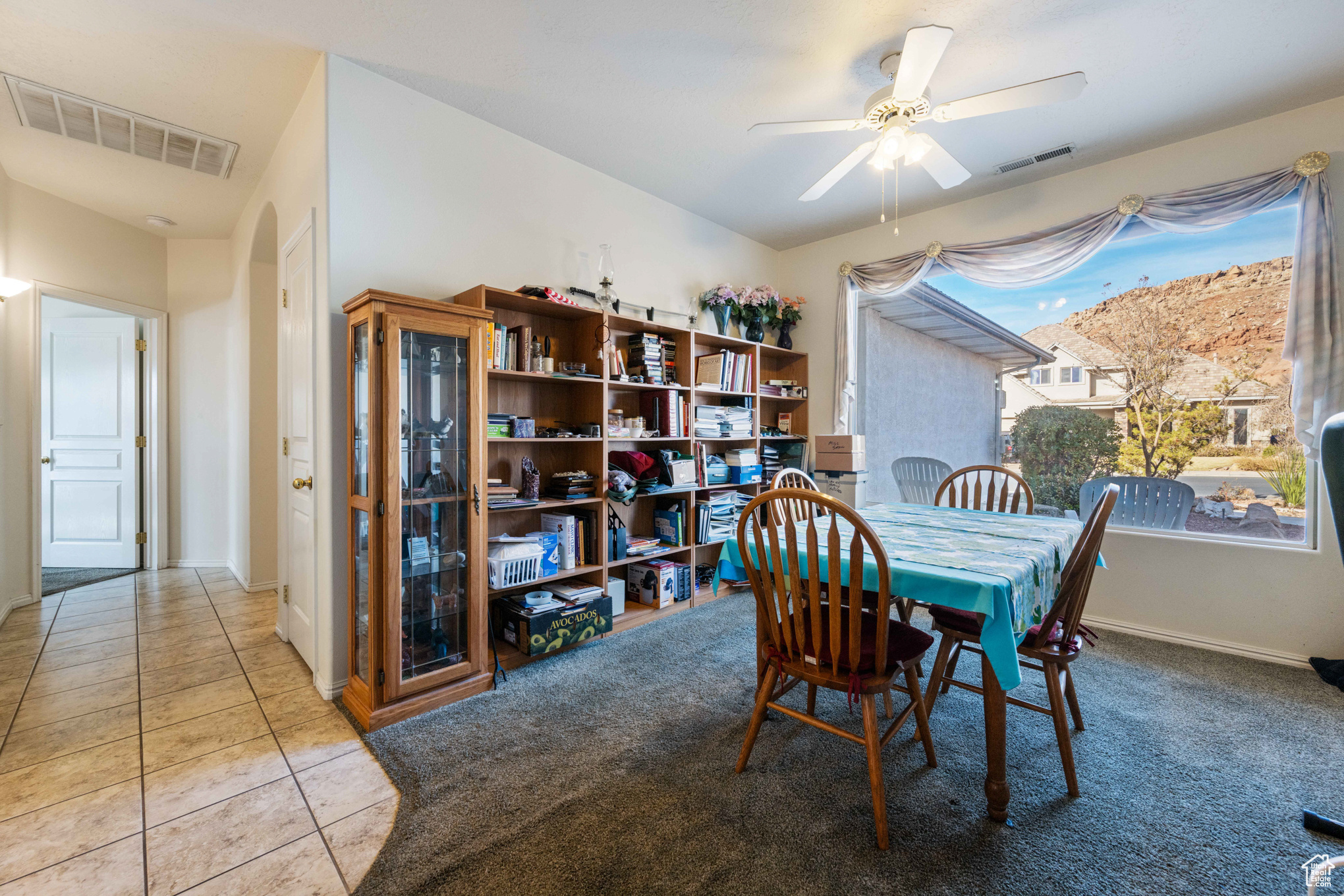 Dining area featuring light colored carpet and ceiling fan