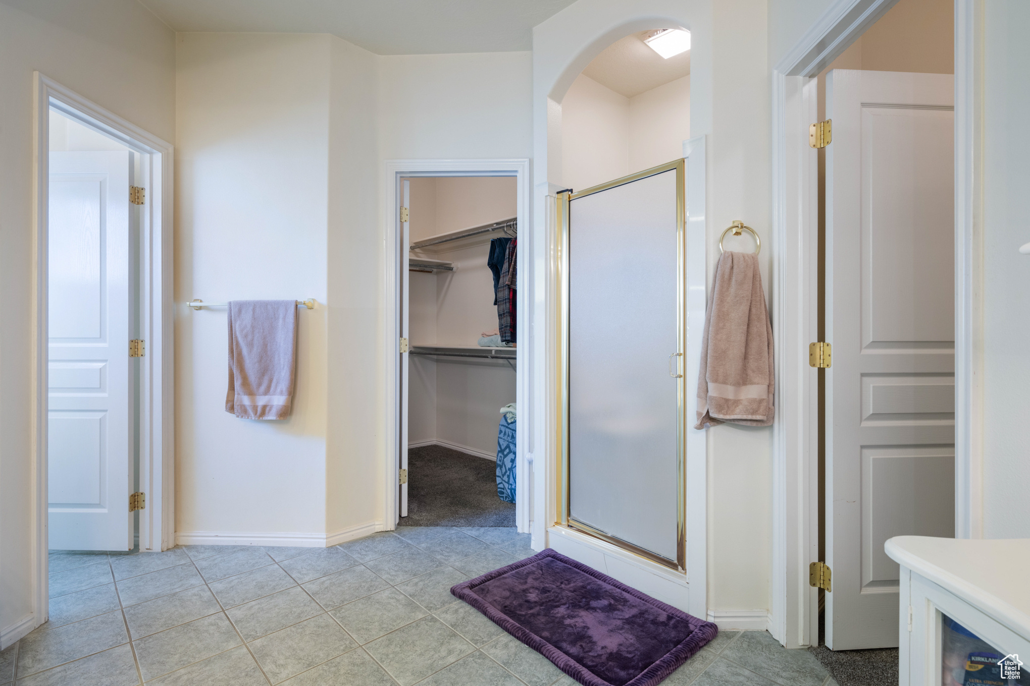 Bathroom featuring a shower with door