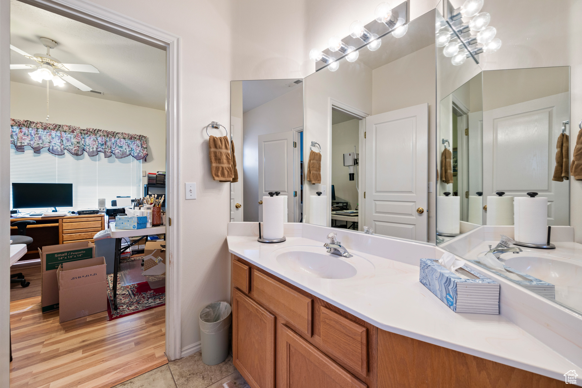 Bathroom with tile patterned floors, ceiling fan, and vanity