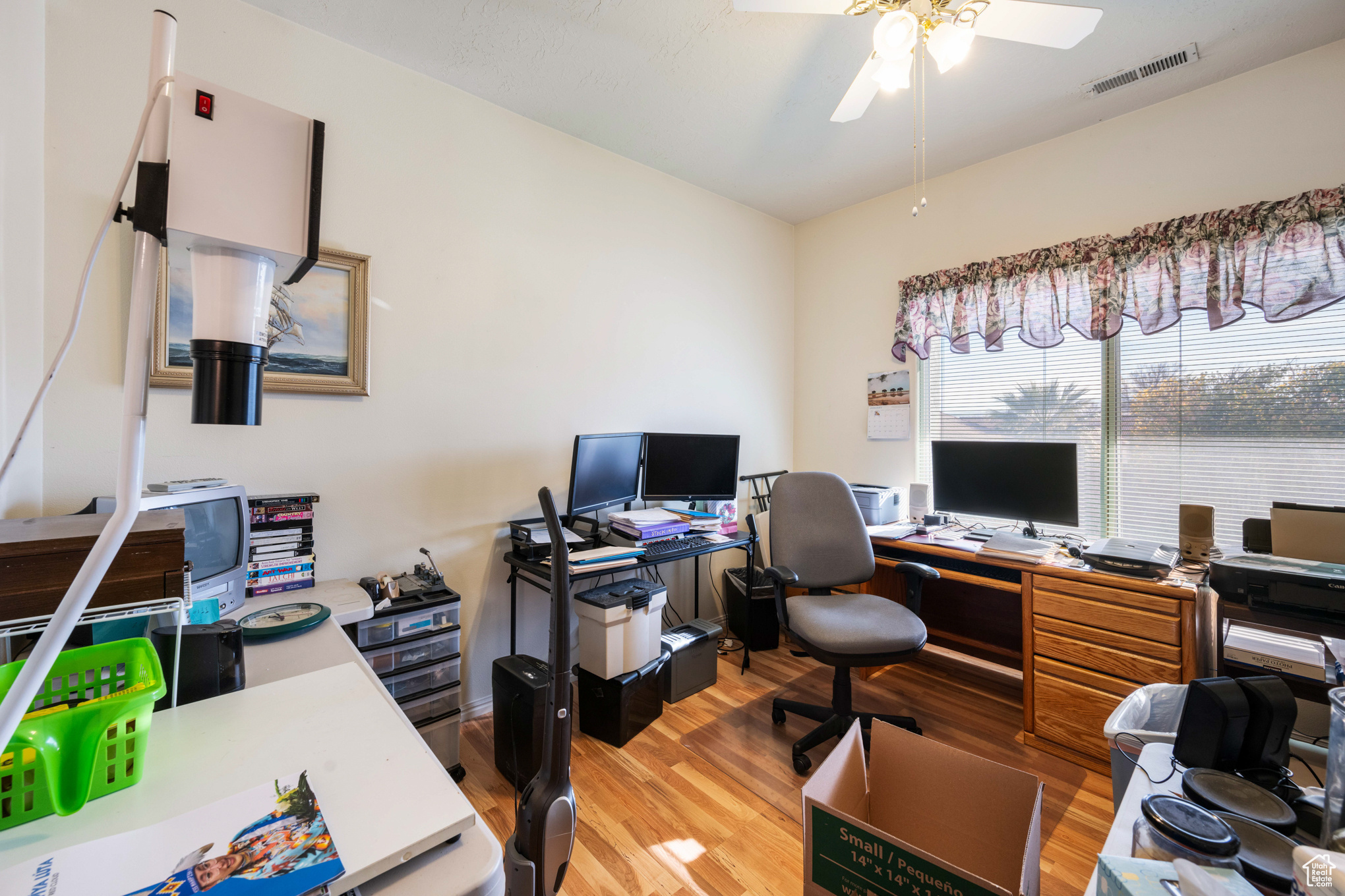 Office area with ceiling fan and wood-type flooring