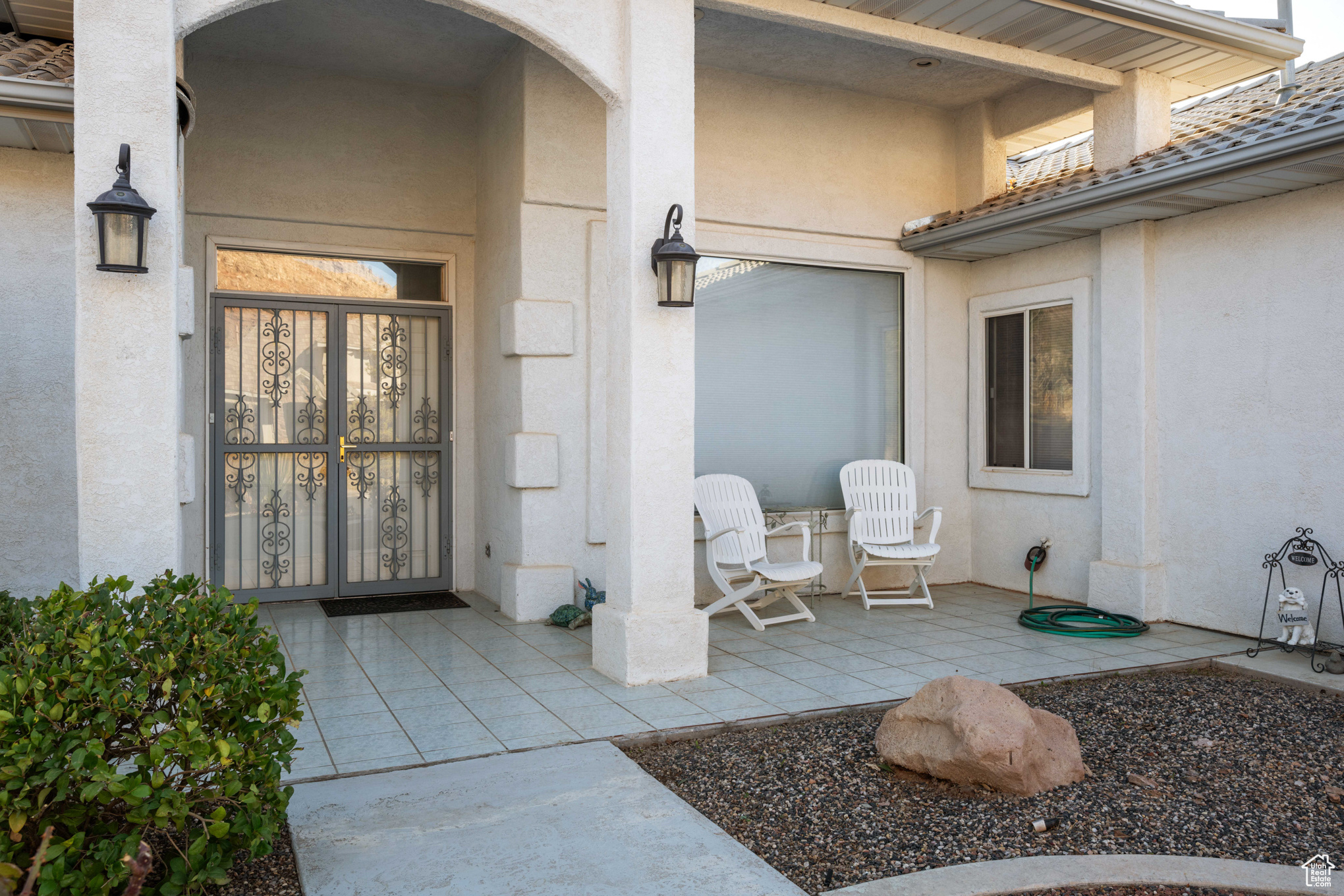 Doorway to property with a patio area