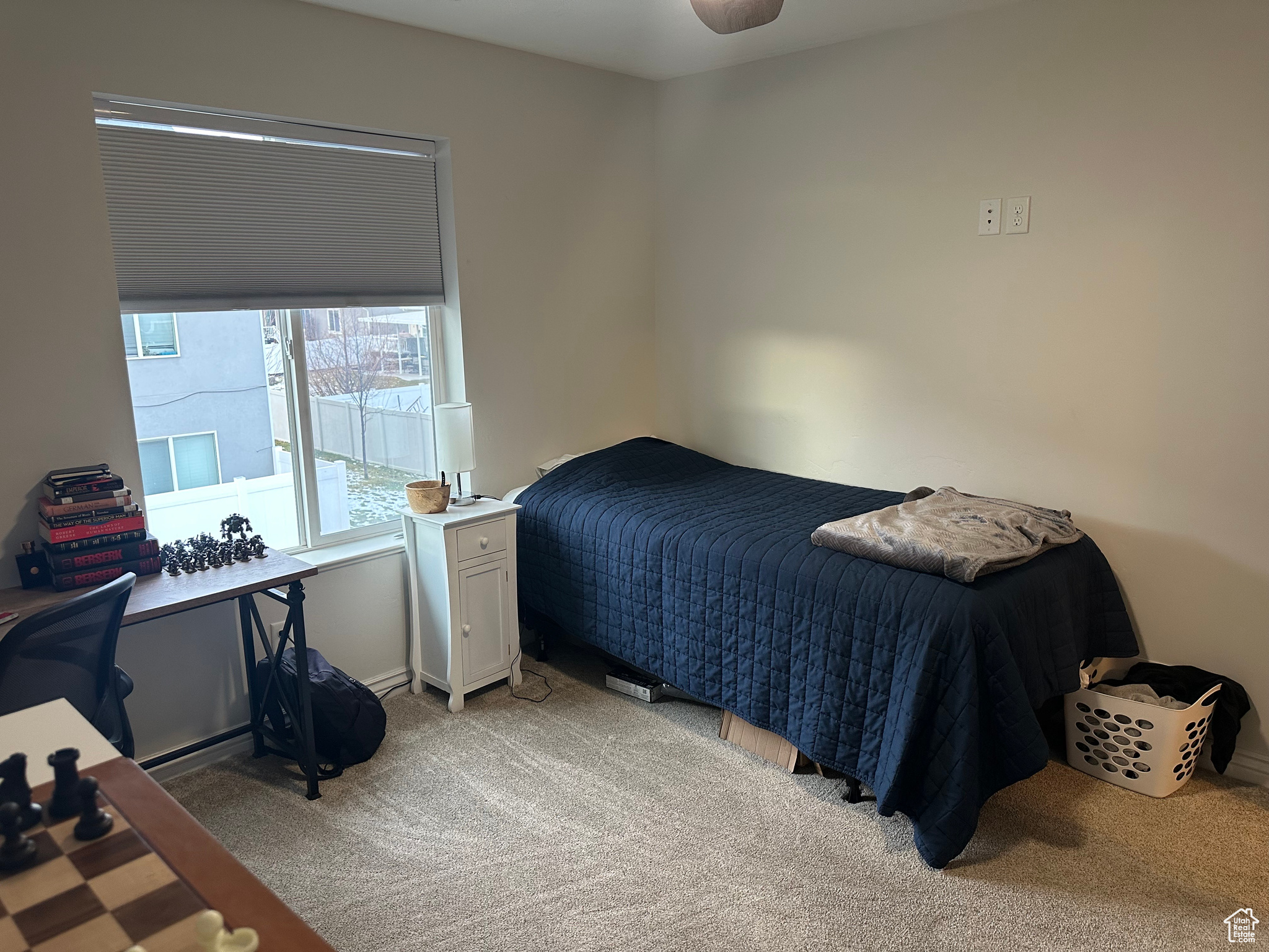 Carpeted bedroom with ceiling fan