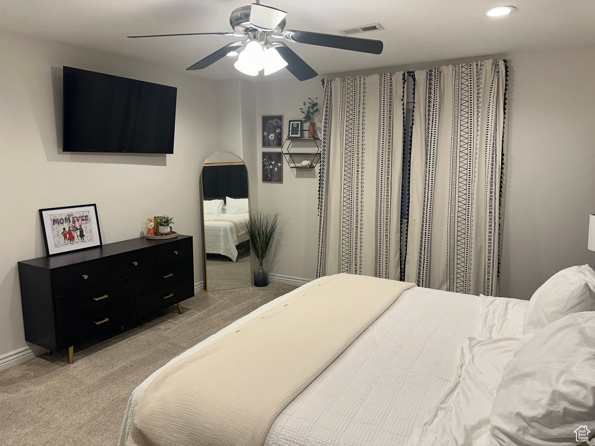 Bedroom featuring light colored carpet and ceiling fan