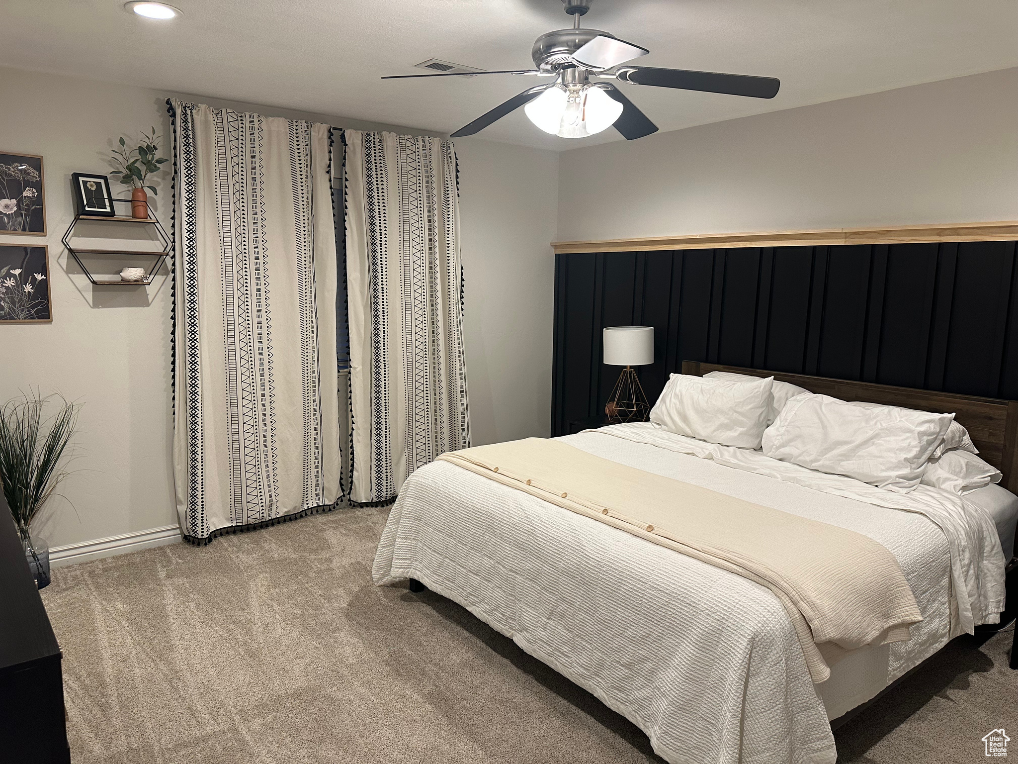 Bedroom featuring ceiling fan and light colored carpet