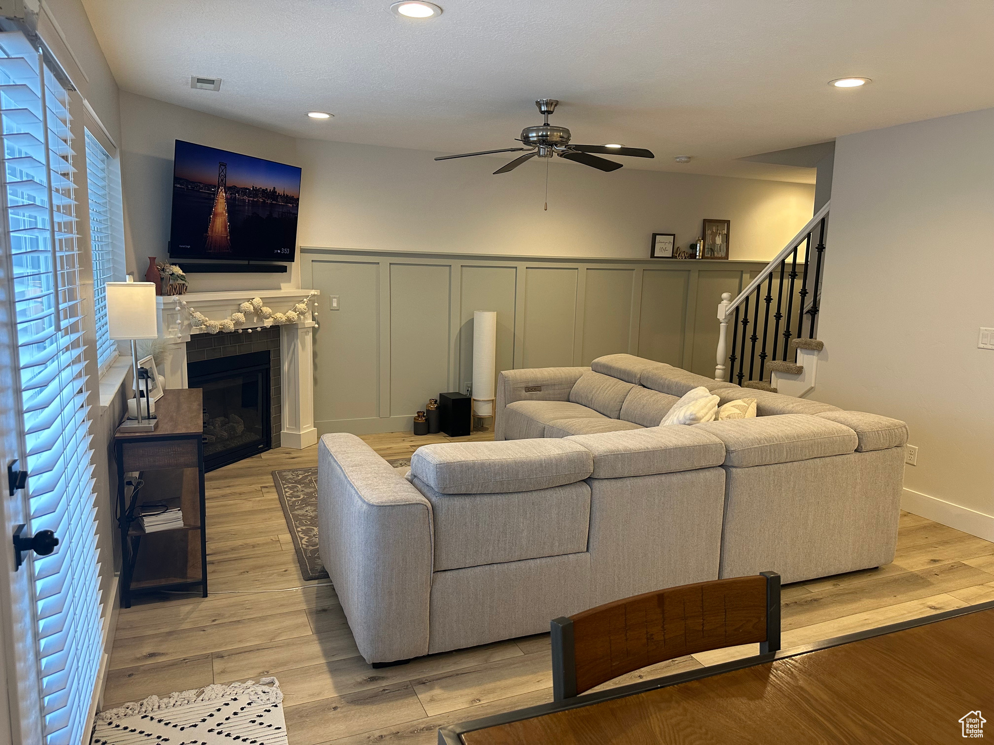 Living room featuring light wood-type flooring and ceiling fan