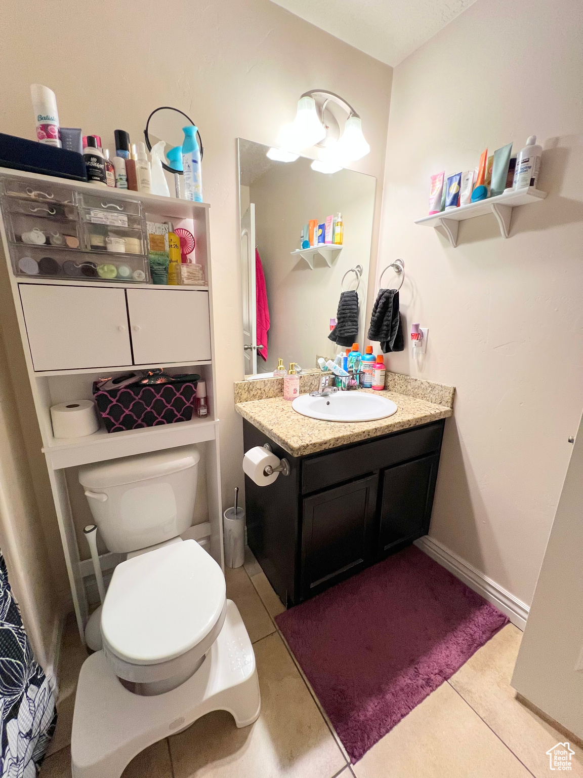 Bathroom with tile patterned flooring, vanity, and toilet