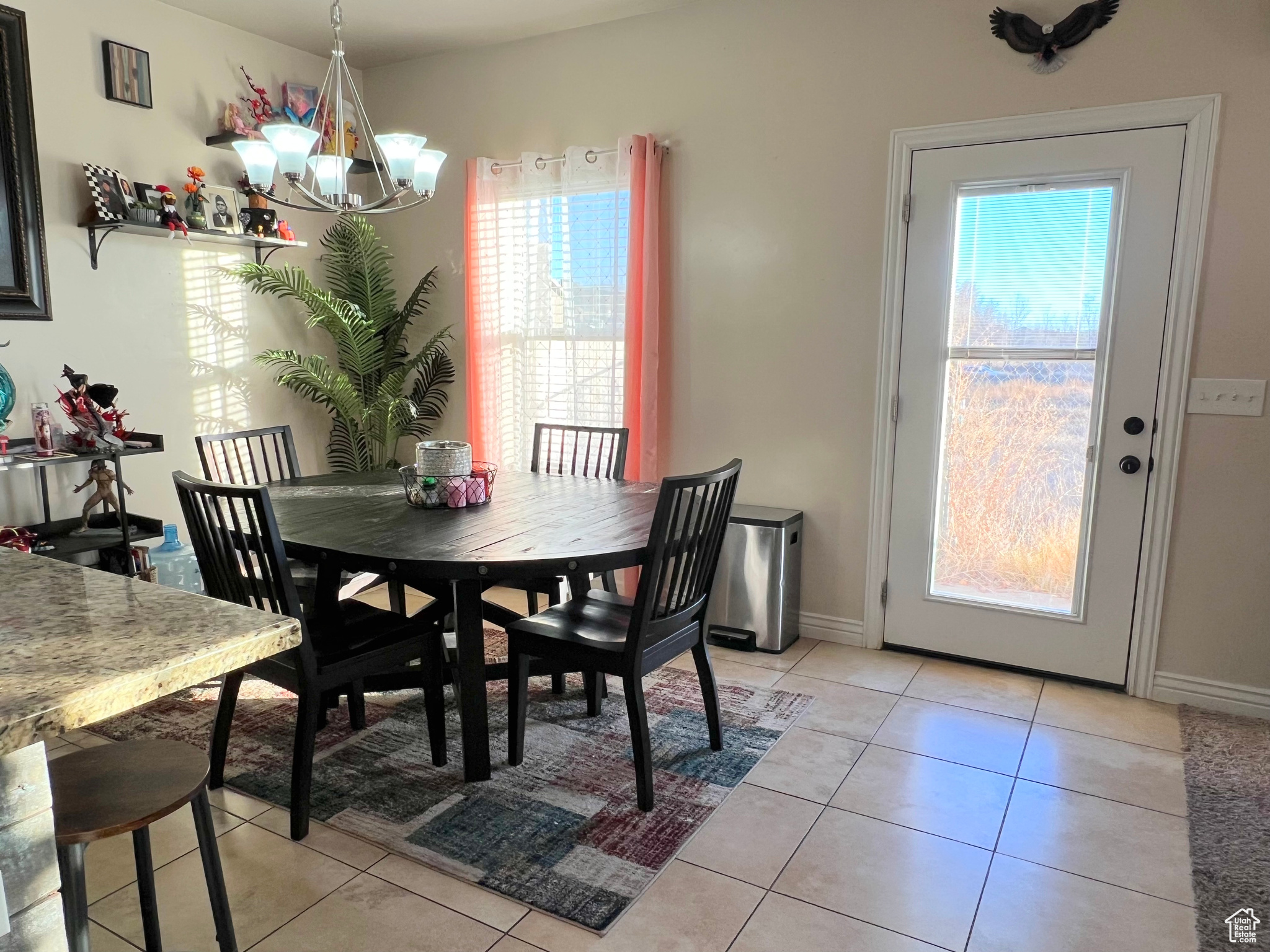 Dining room featuring a chandelier and light tile patterned floors