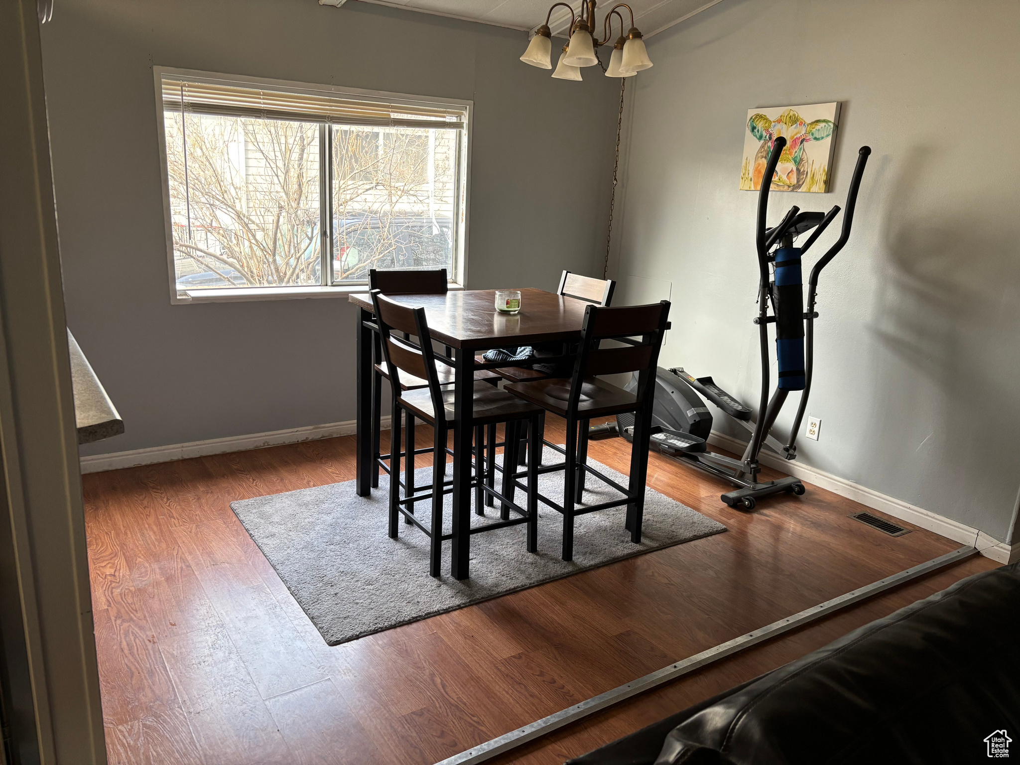 Dining room featuring wood-type flooring and an inviting chandelier