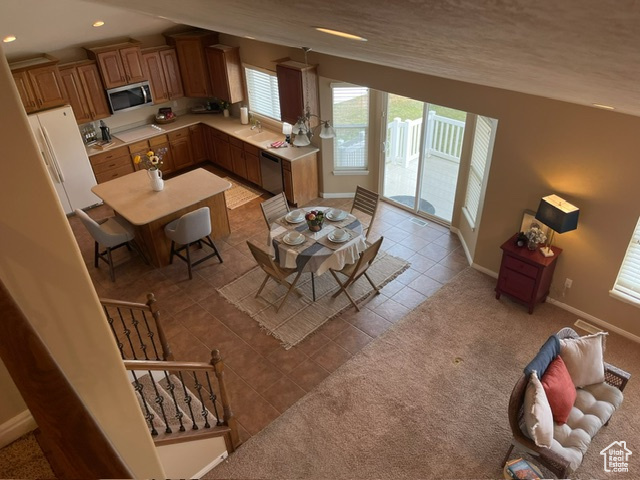 Kitchen featuring light tile patterned floors, sink, and appliances with stainless steel finishes