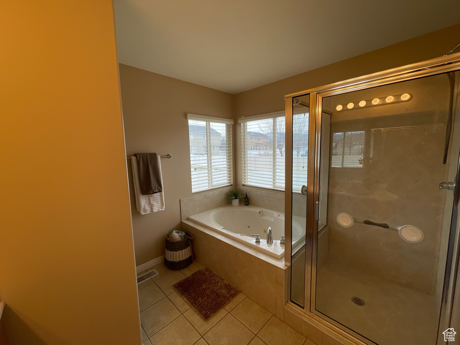 Bathroom with tile patterned flooring and independent shower and bath