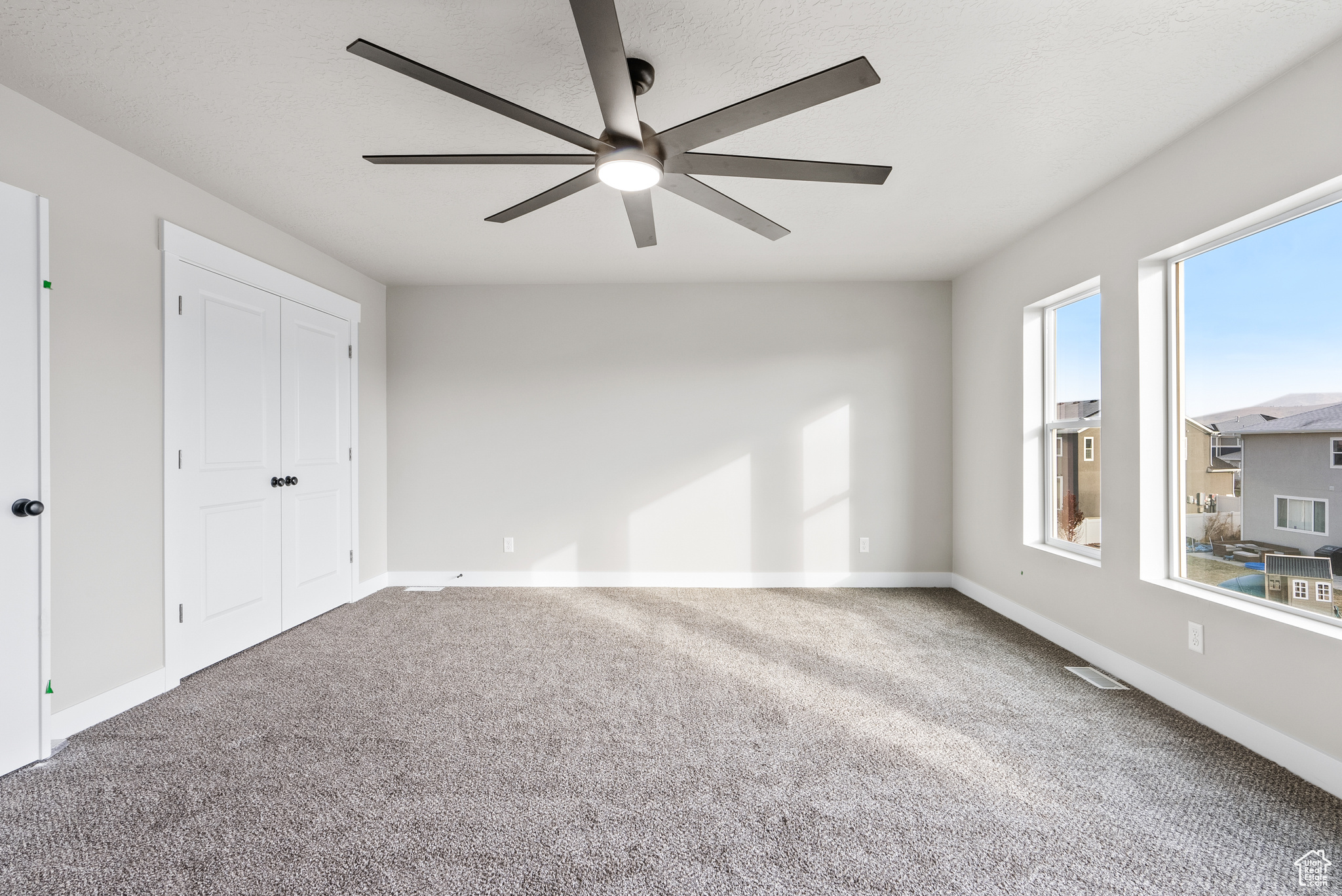 Interior space featuring ceiling fan and carpet floors