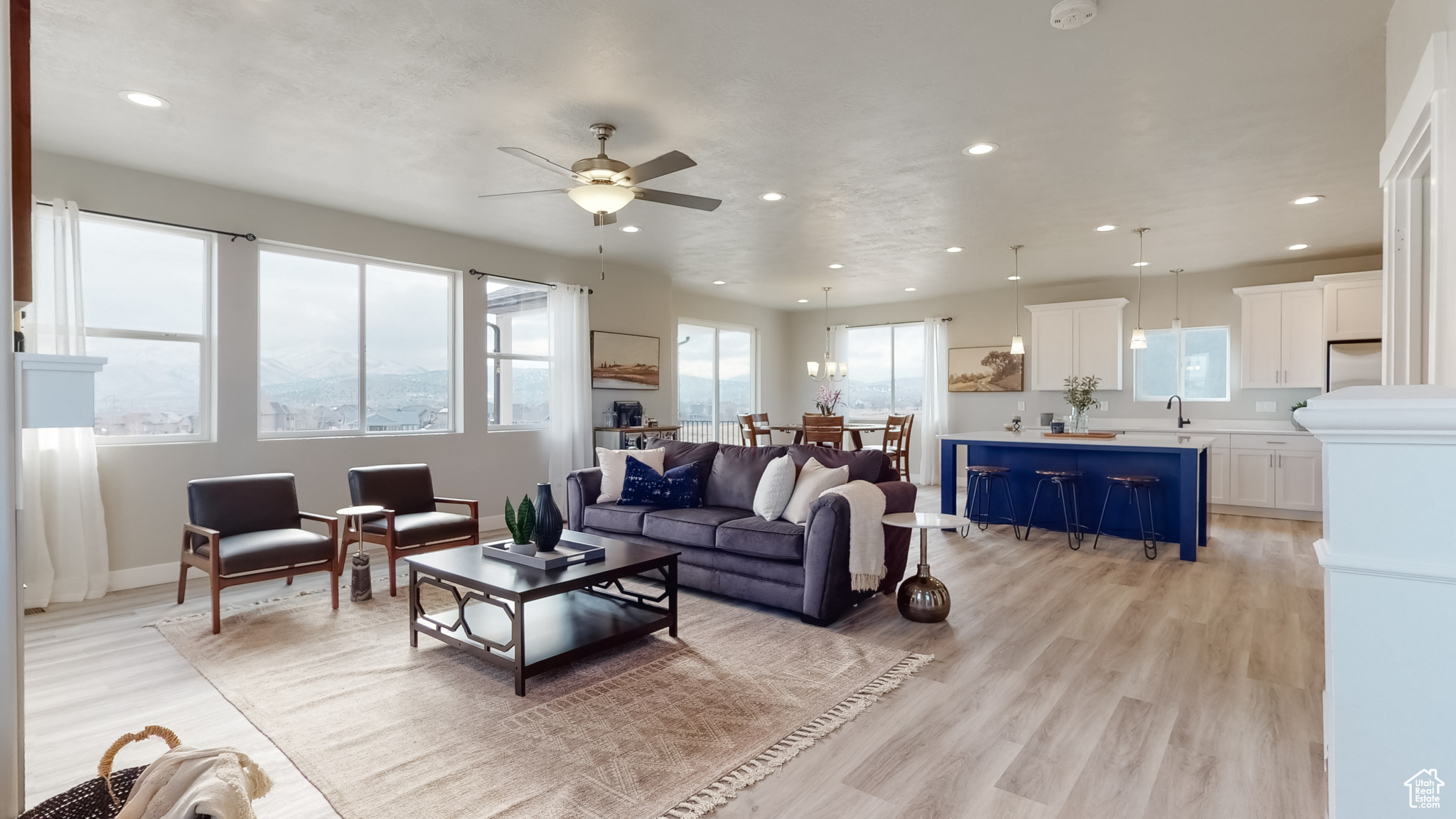 Living room featuring ceiling fan, plenty of natural light, light hardwood / wood-style floors, and sink