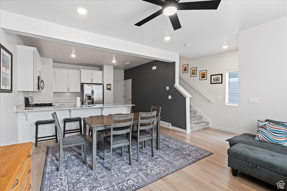 Dining area featuring ceiling fan and light hardwood / wood-style floors