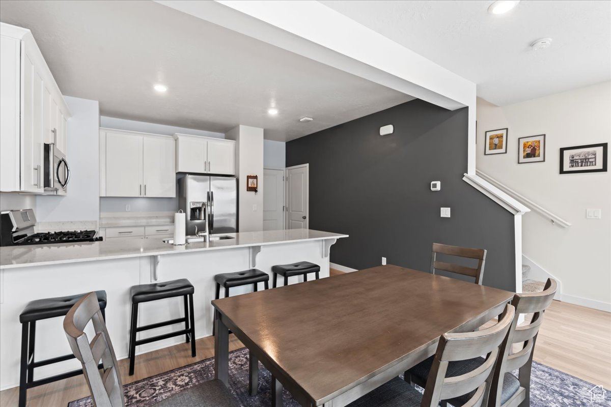 Dining space with light wood-type flooring