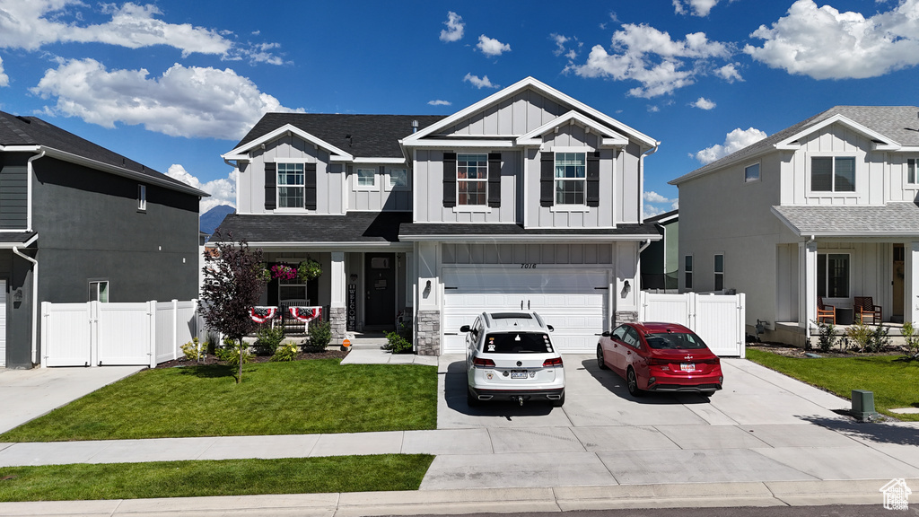 View of front of house with a garage and a front lawn