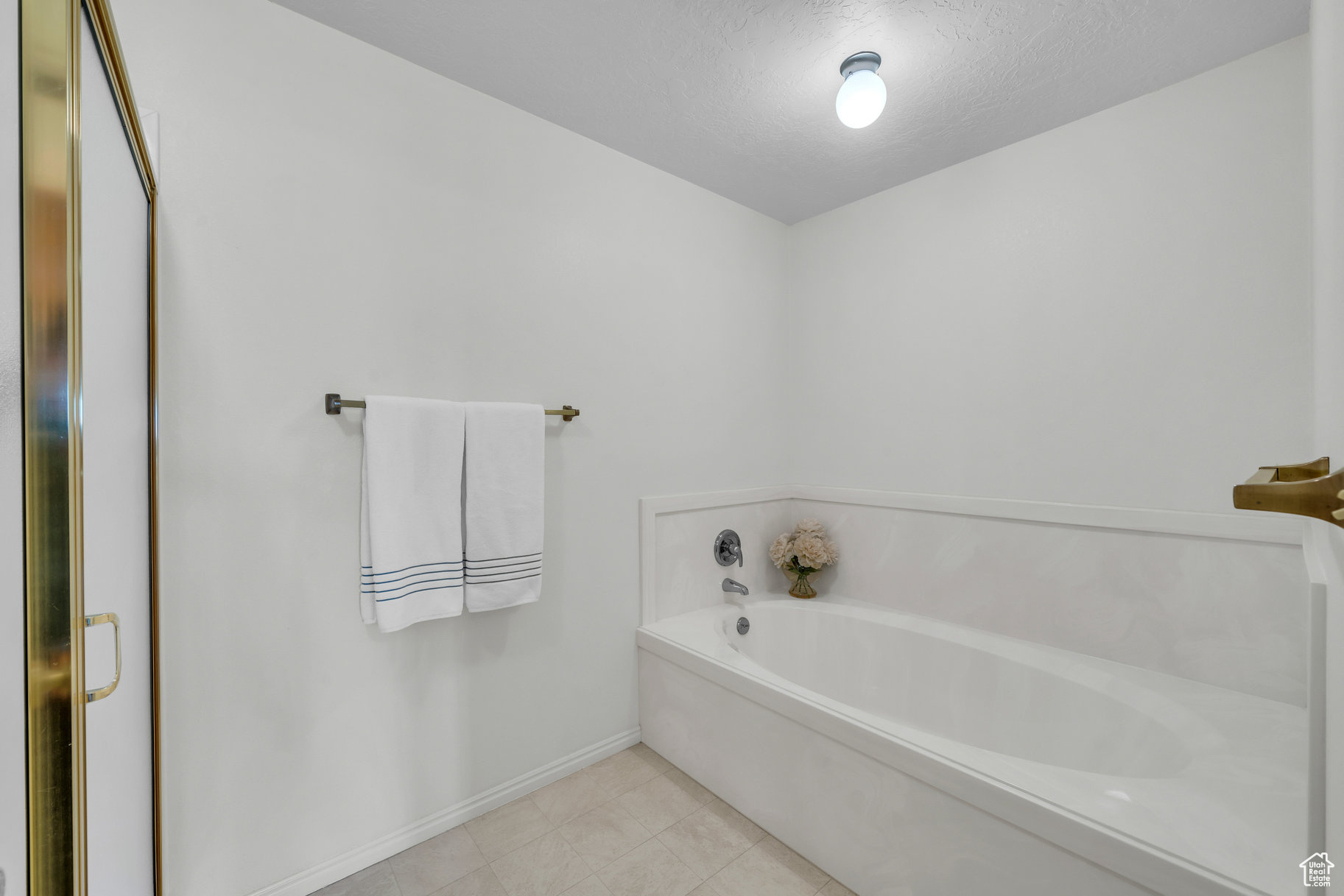 Bathroom featuring a bathtub and a textured ceiling