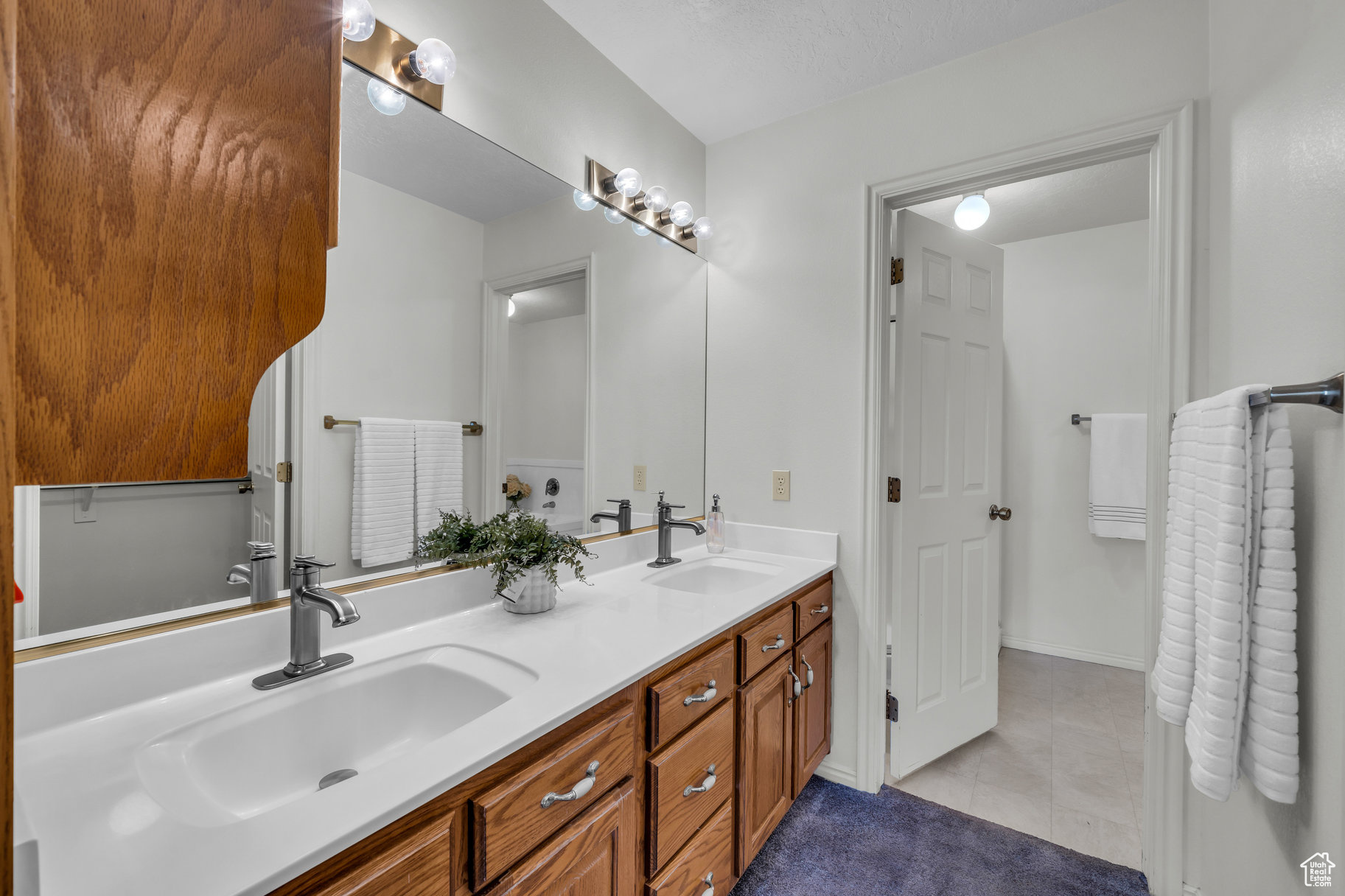 Bathroom featuring tile patterned floors, vanity, and a textured ceiling