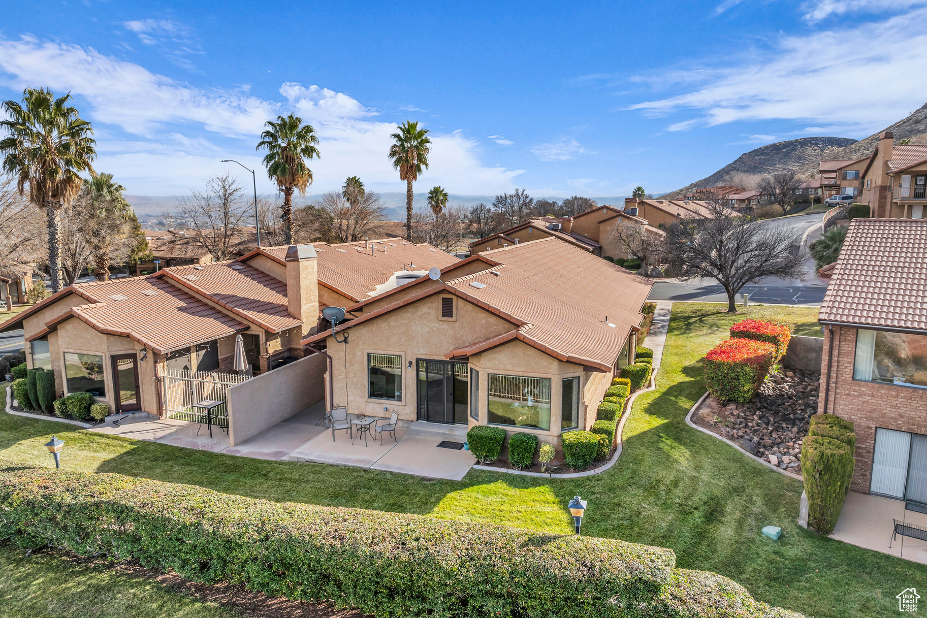 Rear view of property featuring a lawn and a patio area