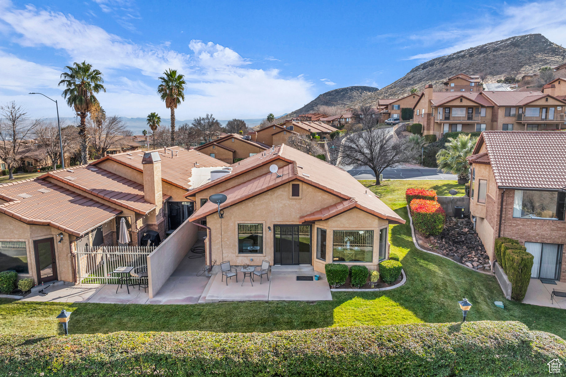 Rear view of house with a mountain view and a yard