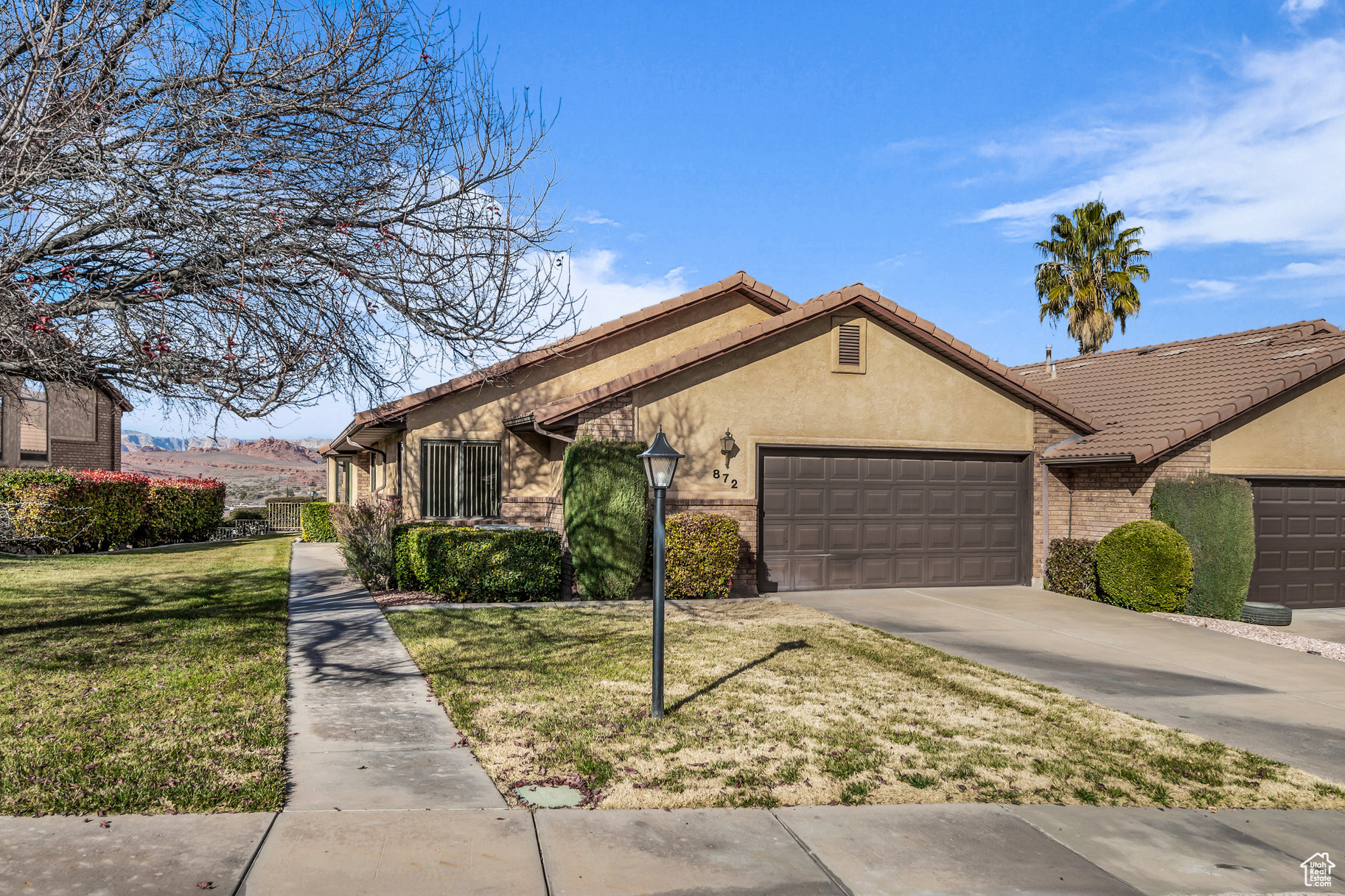 Single story home featuring a front yard and a garage