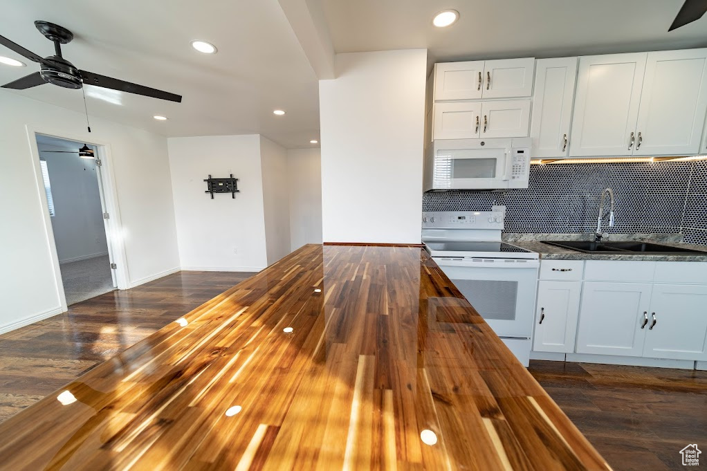 Kitchen featuring butcher block countertops, white cabinets, white appliances, and sink