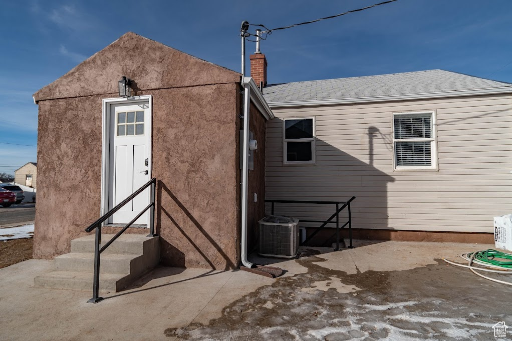 Rear view of house with central AC