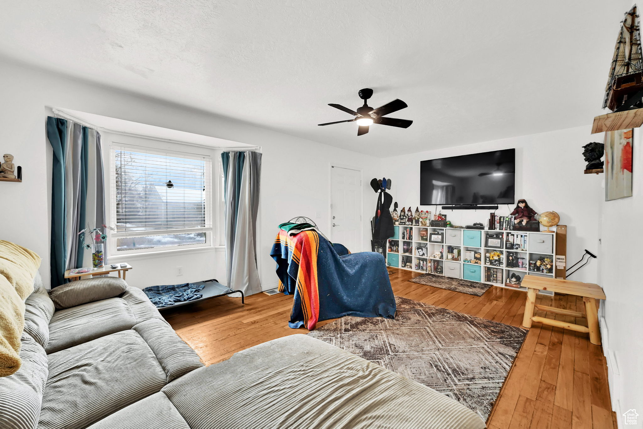 Living room featuring hardwood / wood-style floors and ceiling fan