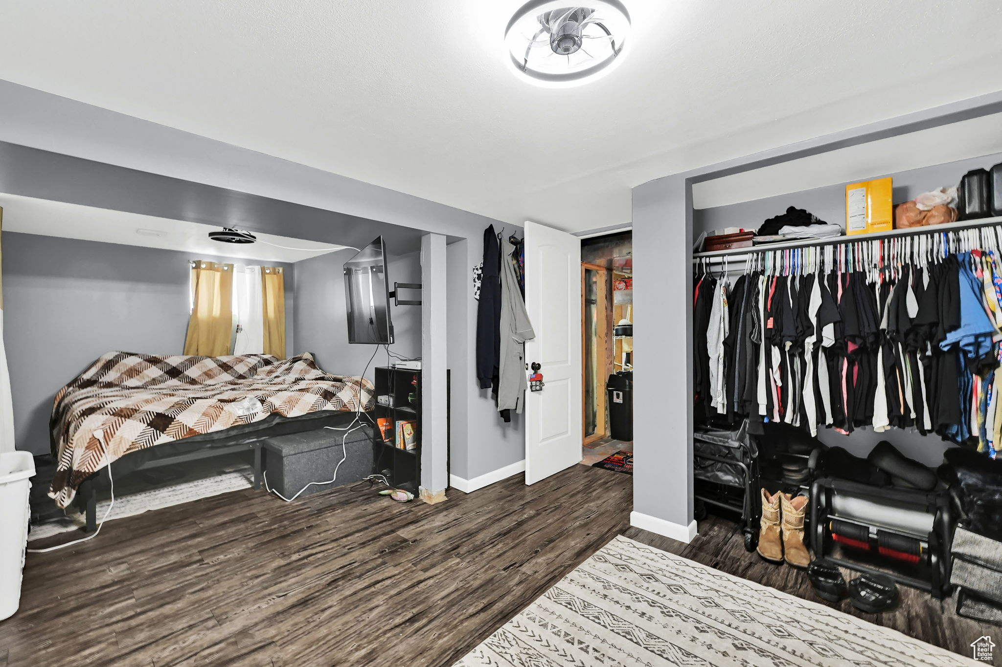 Bedroom featuring dark hardwood / wood-style floors and a closet