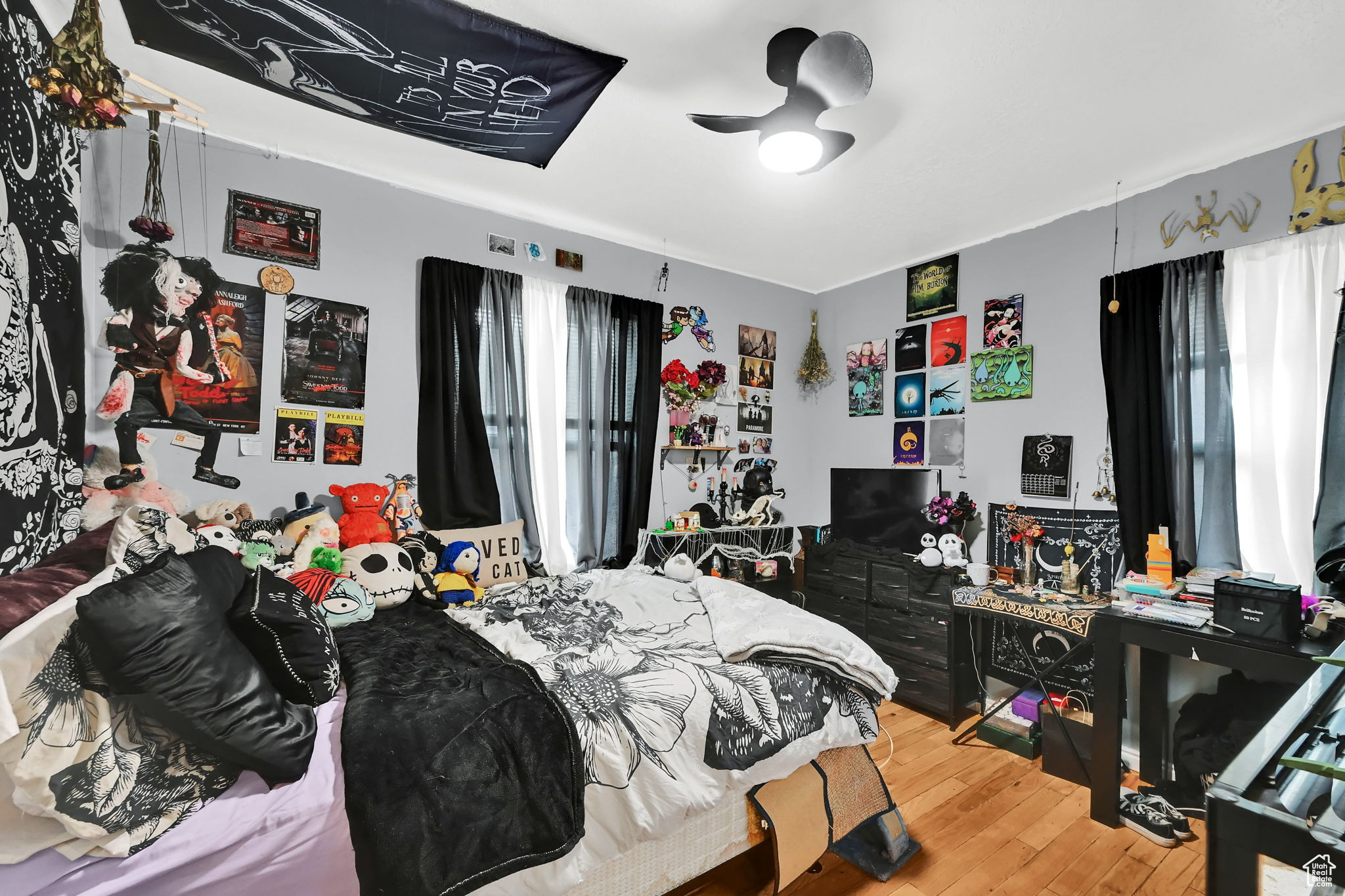 Bedroom with hardwood / wood-style floors and ceiling fan