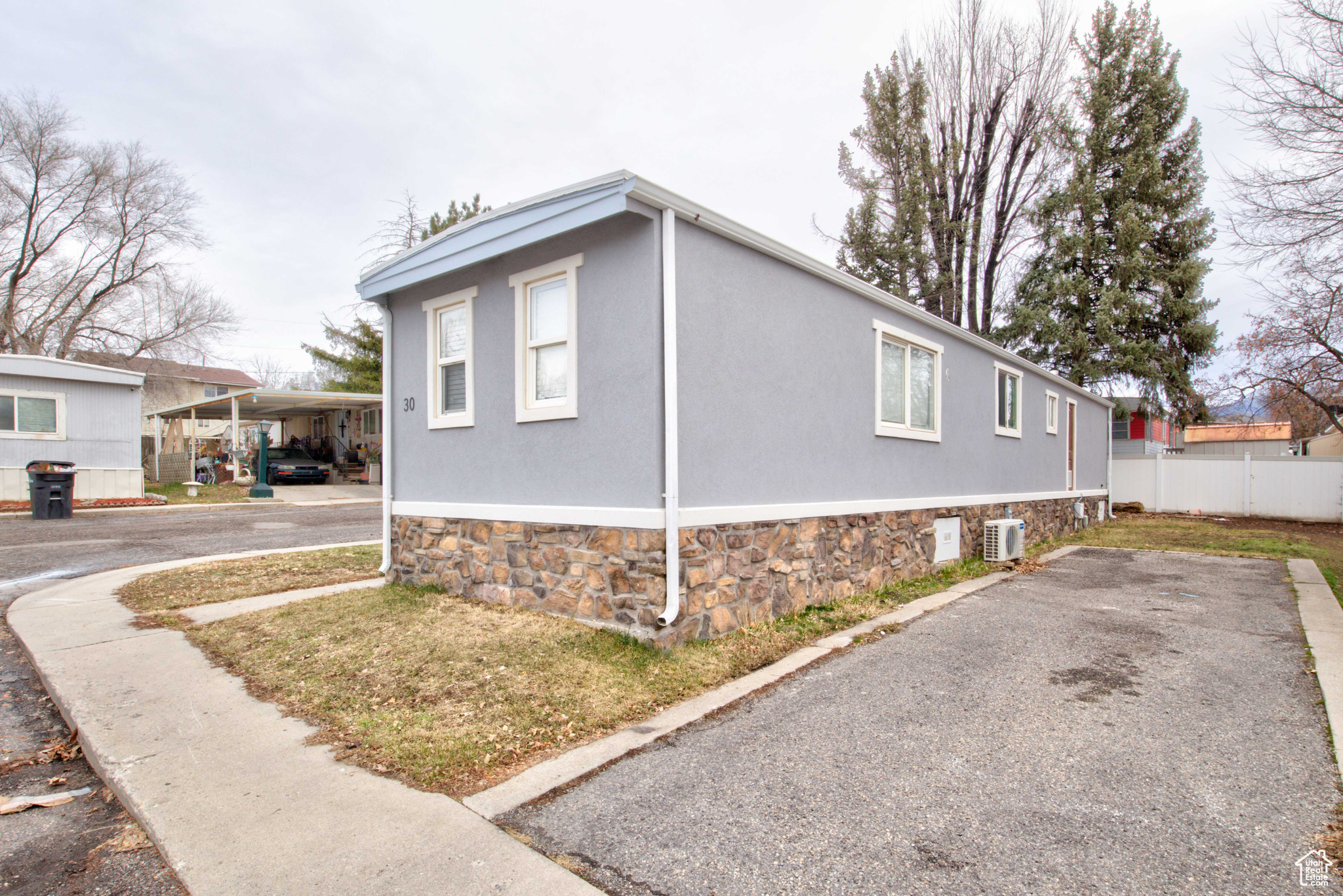 View of side of home with a carport