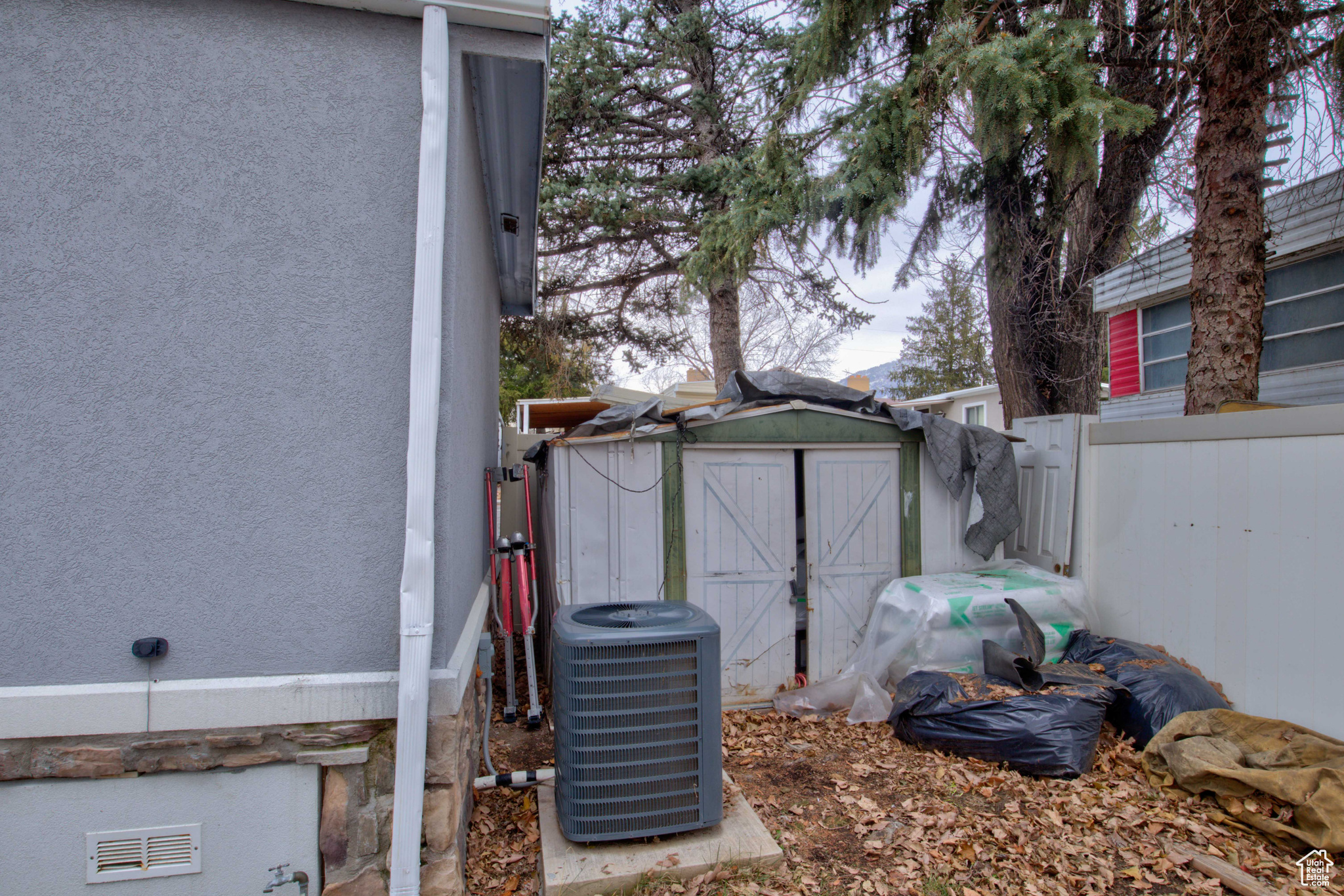 Exterior space featuring central AC unit and a shed