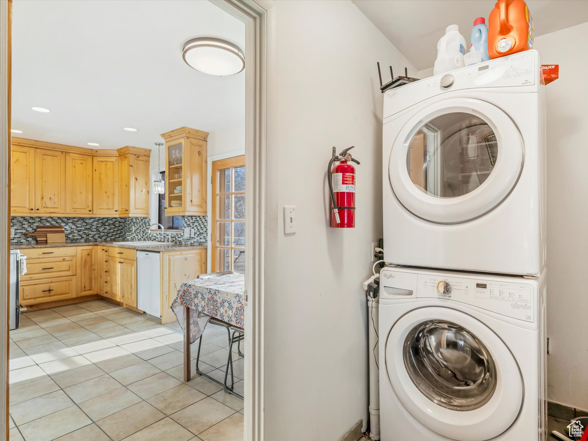 Clothes washing area with stacked washer and dryer