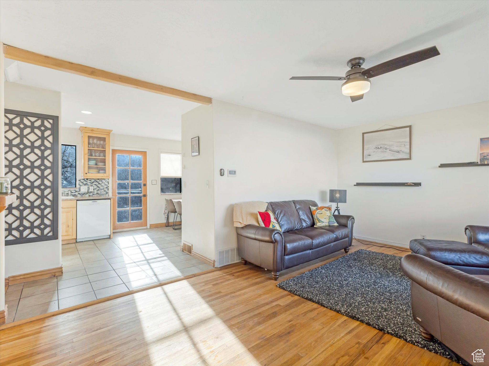 Living room with ceiling fan and light hardwood flooring