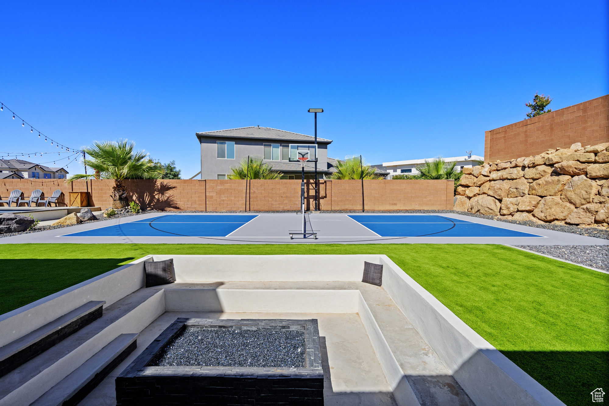 Exterior space featuring basketball hoop and a lawn