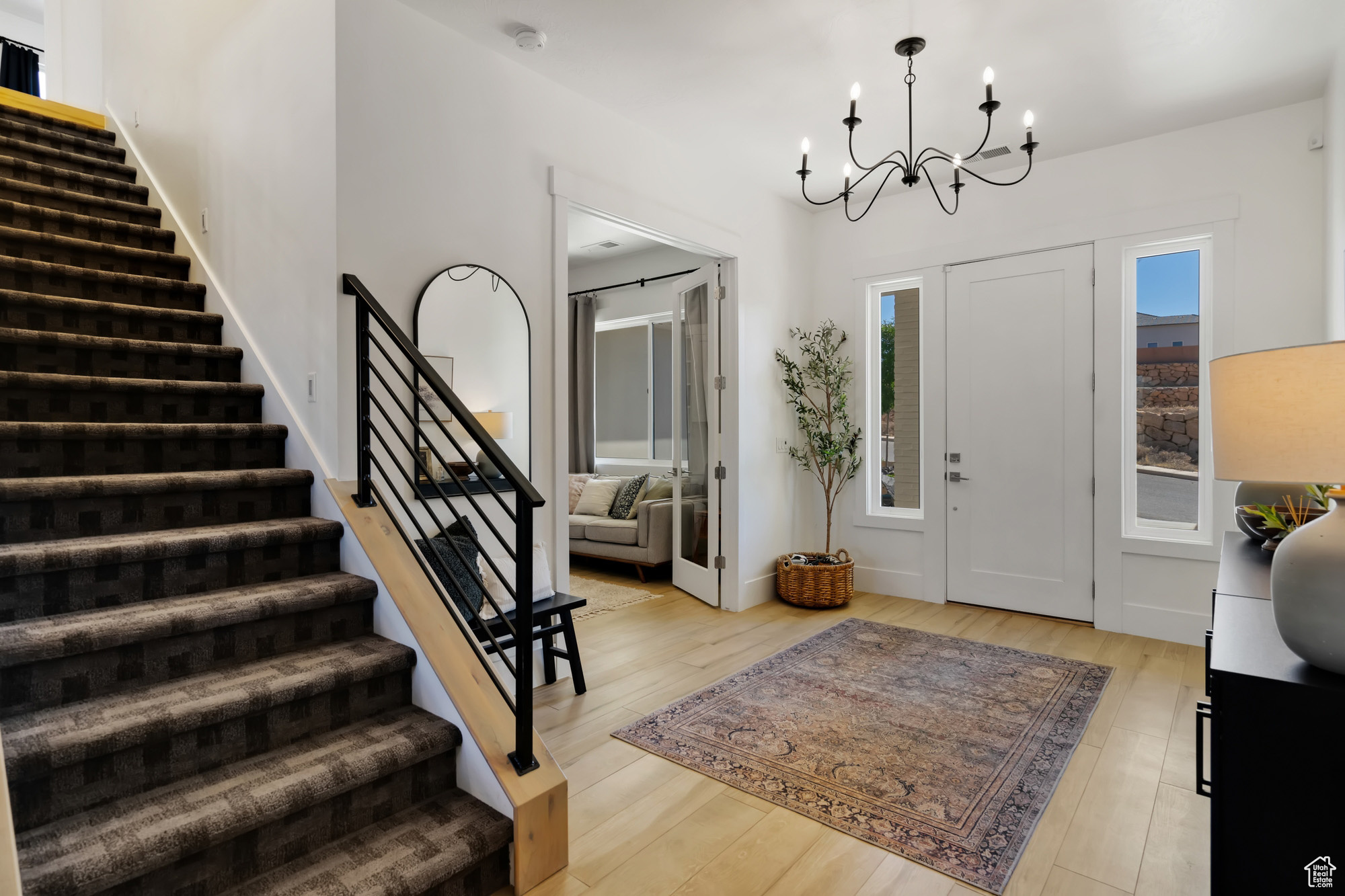 Entryway with a chandelier and light hardwood / wood-style flooring