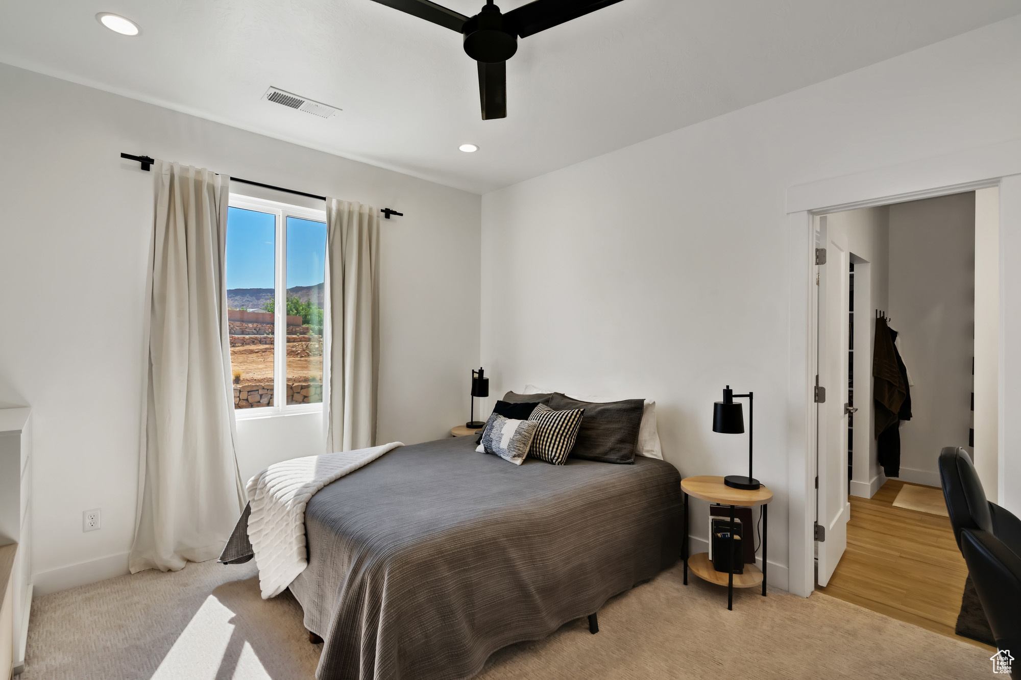 Bedroom featuring light carpet and ceiling fan