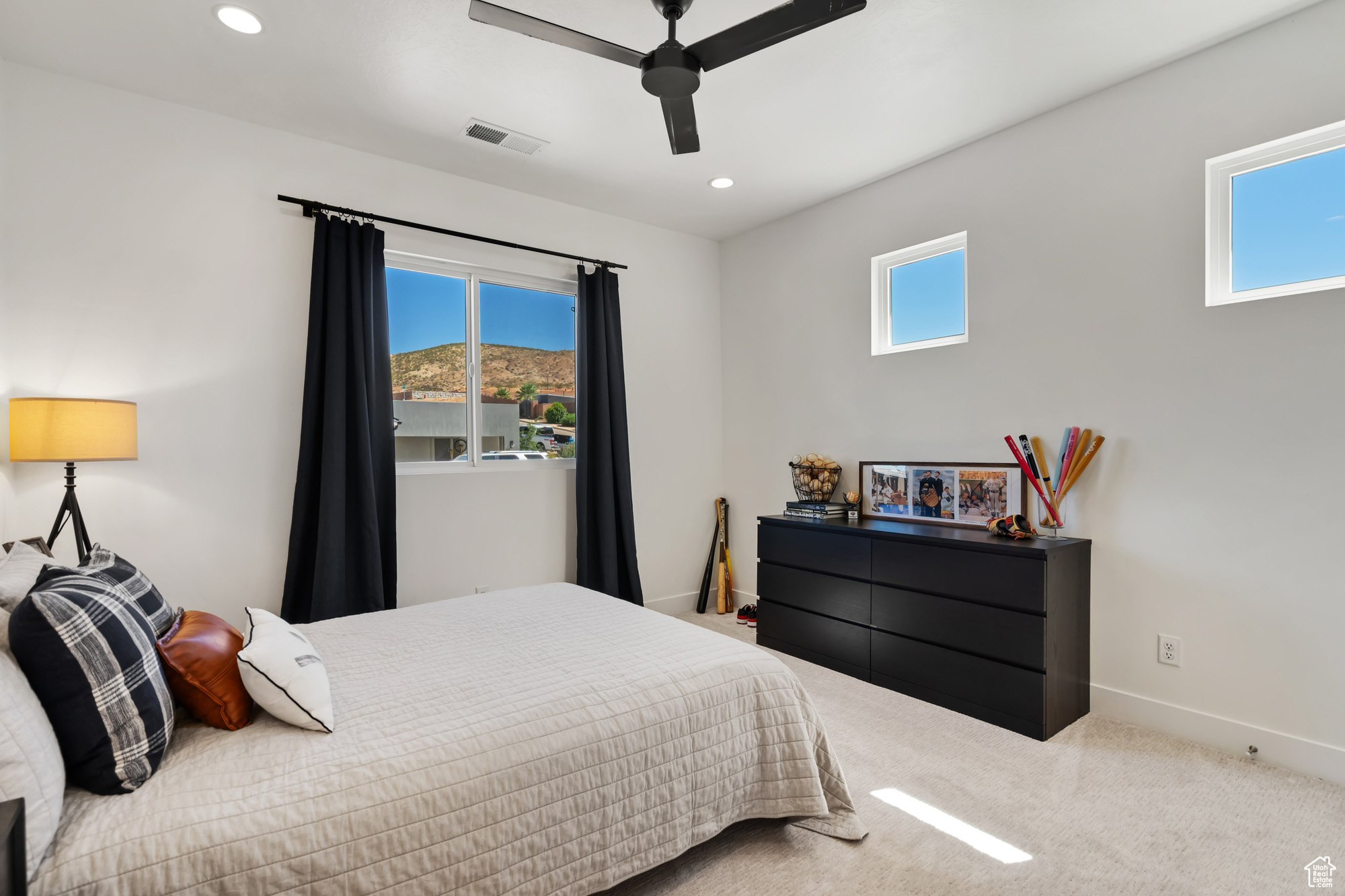 Bedroom with ceiling fan and multiple windows