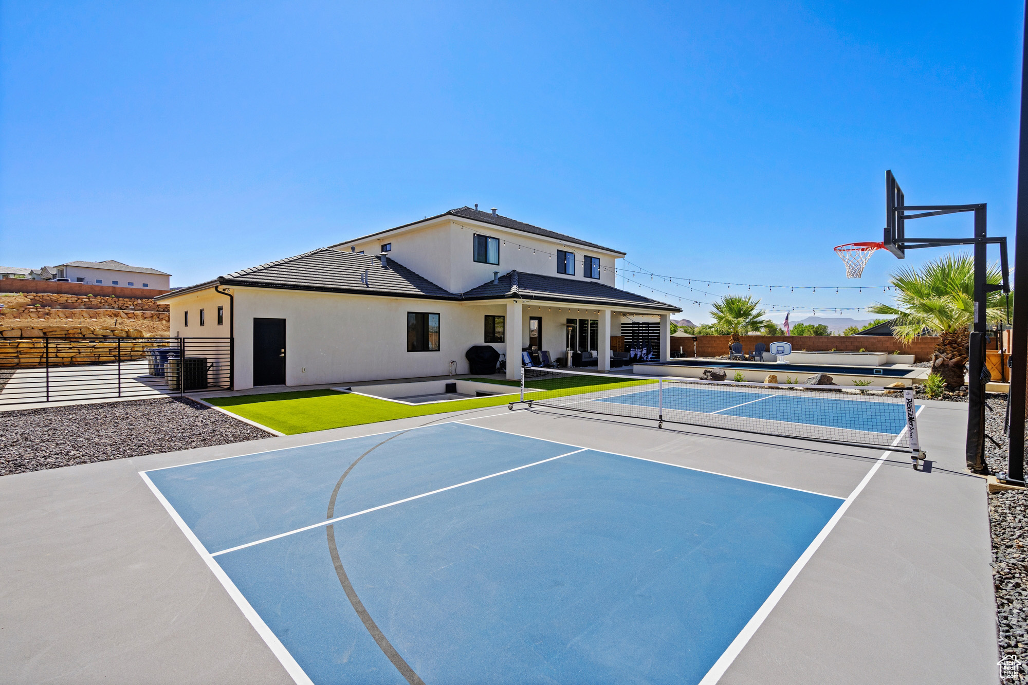 View of basketball court featuring tennis court